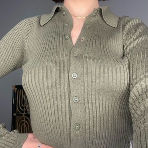 Dark green rubbed sweater with collar and buttons.